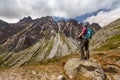 Hiking woman admiring the beauty of rocky Tatra mountains