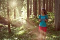 Happy woman with backpack walking on hiking trail path in forest woods during sunny day.Group of friends people summer Royalty Free Stock Photo