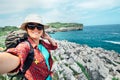 Happy woman backpacker traveler take a selfie photo on amazing o