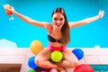 Happy woman with balloons and cocktail at poolside Royalty Free Stock Photo