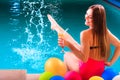 Happy woman with balloons and cocktail at poolside Royalty Free Stock Photo