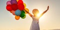 Happy woman with balloons at sunset in summer Royalty Free Stock Photo