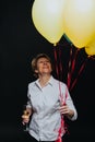 Happy woman with balloons and wineglass