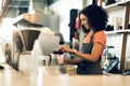 Happy woman, barista and small business owner at cafe for service, coffee or beverage by counter at store. Female person Royalty Free Stock Photo