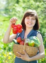 Happy woman with basket of harvested vegetables Royalty Free Stock Photo