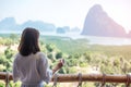 Happy woman in bathrobe holding hot coffee cup or tea mug after waking up and enjoy Phang Nga bay view point, Tourist relaxing in Royalty Free Stock Photo