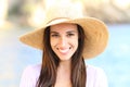 Happy woman on the beach looking at camera smiling Royalty Free Stock Photo