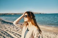 happy woman on the beach near the sea in the mountains glasses on the face red hair model landscape Royalty Free Stock Photo