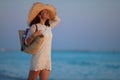 Happy woman on beach at sunset enjoying calming environment