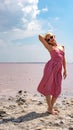 Lady in a beautiful dress young with tender lips against the background of a red lake blue clouds in hot sunny weather Royalty Free Stock Photo