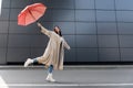 happy woman in beige coat and Royalty Free Stock Photo