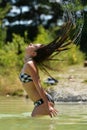 Happy woman in bikini posing on beach