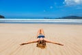 Happy woman in bikini relax, enjoy sunbathing on sand beach Royalty Free Stock Photo