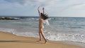 Happy woman in bikini and shirt running on the sandy beach near the ocean. Young beautiful girl enjoying life and having Royalty Free Stock Photo