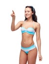 Happy woman in bikini swimsuit pointing finger Royalty Free Stock Photo