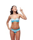 Happy woman in bikini swimsuit pointing finger up Royalty Free Stock Photo