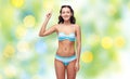 Happy woman in bikini swimsuit pointing finger up Royalty Free Stock Photo