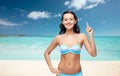 Happy woman in bikini swimsuit pointing finger up Royalty Free Stock Photo