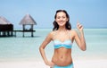 Happy woman in bikini swimsuit pointing finger up Royalty Free Stock Photo