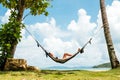 Happy woman in black bikini relaxing in hammock Royalty Free Stock Photo