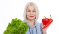 Happy woman with blond hair and beautiful smile holds red pepper and green lettuce in her hands for a healthy diet with Royalty Free Stock Photo