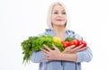 Happy woman with blond hair and beautiful smile holds a vegetables and herbs red pepper and green lettuce in her hands Royalty Free Stock Photo
