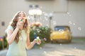 Happy woman blowing soap bubbles Royalty Free Stock Photo