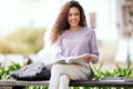 Happy woman, books and university with student on campus, learning with scholarship at college and outdoor. Female Royalty Free Stock Photo