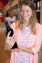 happy woman with bottles wine in store Royalty Free Stock Photo