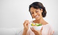 Happy woman, bowl and eating salad for healthy diet, natural nutrition or wellness on living room sofa at home. Female Royalty Free Stock Photo