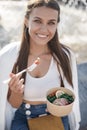 Happy woman with bowl fitness food salmon and vegetables, caucasian woman outdoor