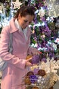 Happy woman buying sparkling Christmas decorations