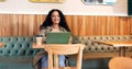 Happy woman in cafe, typing on laptop and remote work, reading email or writing blog, article or search on technology Royalty Free Stock Photo