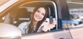 Happy woman with car key sitting in auto outdoors on sunny day. Banner design Royalty Free Stock Photo