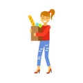 Happy woman carrying a brown shopping bag with food products. Shopping in grocery store, supermarket or retail shop Royalty Free Stock Photo