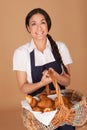 Happy woman carrying fresh croissants