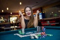 Happy woman in casino with poker chips and cards Royalty Free Stock Photo