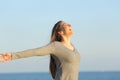 Happy woman celebrating good day on the beach Royalty Free Stock Photo