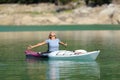 Happy woman celebrating kayak day in a lake