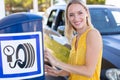 happy woman checking car tyre pressure Royalty Free Stock Photo