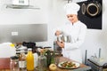 Happy woman chef cooking food at kitchen Royalty Free Stock Photo