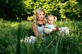 Happy woman and child in the blooming spring garden.Mothers day holiday or womans day concept Royalty Free Stock Photo