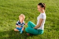 Happy woman and child having fun outdoor on meadow Royalty Free Stock Photo