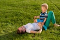 Happy woman and child having fun outdoor on meadow Royalty Free Stock Photo