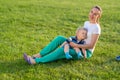 Happy woman and child having fun outdoor on meadow Royalty Free Stock Photo