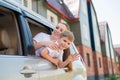 Happy woman and child look out of a car window. Cheerful boy with his mother are sitting in the back seat of the car and Royalty Free Stock Photo