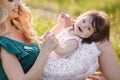 Happy woman with a child resting on the nature Royalty Free Stock Photo