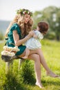Happy woman with a child resting on the nature Royalty Free Stock Photo