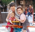 Happy woman children on swings Royalty Free Stock Photo