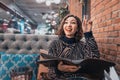 woman chooses food and drinks from a large menu in a restaurant Royalty Free Stock Photo